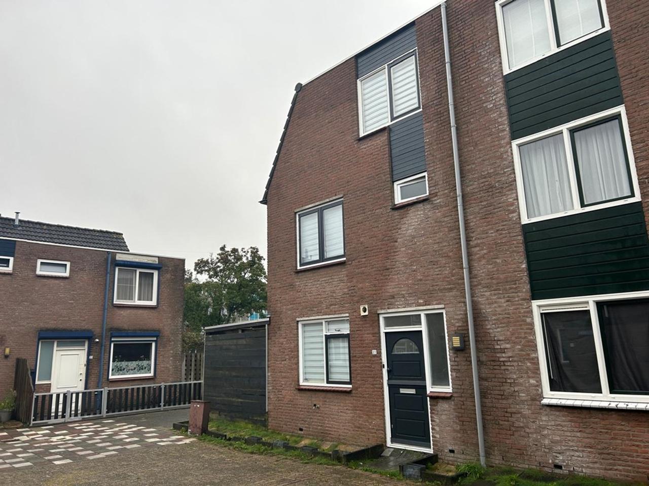 Hoekwoning met tuin naast supermarkt - Afbeelding 1